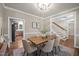 Dining room featuring a rustic wooden table with neutral chairs, flowing seamlessly into other living spaces at 5216 Woods End Rd, Hillsborough, NC 27278