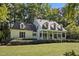 Charming home with a welcoming front porch, manicured lawn, and classic architectural details at 5216 Woods End Rd, Hillsborough, NC 27278