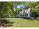 Landscaped lawn and home framed by mature trees in a lovely setting at 5216 Woods End Rd, Hillsborough, NC 27278