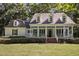 Charming home featuring a spacious front porch,dormer windows,neat landscaping and a well-maintained lawn at 5216 Woods End Rd, Hillsborough, NC 27278