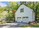 Detached two-car garage with matching design, complemented by a gravel driveway and neat landscaping at 5216 Woods End Rd, Hillsborough, NC 27278