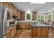 Kitchen with granite countertops, stainless steel appliances, wood cabinets, and kitchen island at 5216 Woods End Rd, Hillsborough, NC 27278