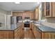 Updated kitchen with granite counters, stainless appliances, hardwood flooring, and wooden cabinets at 5216 Woods End Rd, Hillsborough, NC 27278