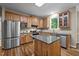 Spacious kitchen featuring granite countertops, stainless appliances, wood cabinets, and kitchen island at 5216 Woods End Rd, Hillsborough, NC 27278