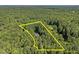 An aerial view highlighting the generous acreage of the property, outlined by yellow property lines at 5216 Woods End Rd, Hillsborough, NC 27278