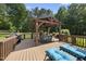 A back deck offers a pergola, outdoor furniture, a grill, and a pair of chaise lounges at 55 Kristopher Woods Dr, Youngsville, NC 27596