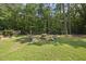 Relax and entertain around the backyard firepit area with comfortable Adirondack chairs for outdoor gathering at 55 Kristopher Woods Dr, Youngsville, NC 27596