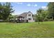 The home features a large backyard with a deck, a pergola, and established trees at 55 Kristopher Woods Dr, Youngsville, NC 27596