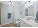 Clean and simple bathroom featuring neutral tile floor, classic vanity, and walk-in shower with glass door at 55 Kristopher Woods Dr, Youngsville, NC 27596
