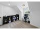Spacious bonus room with storage, sloped ceiling, and workstation setup perfect for work or hobbies at 55 Kristopher Woods Dr, Youngsville, NC 27596