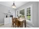 A breakfast nook offers a light fixture, wooden table, backyard views, and a coffee bar at 55 Kristopher Woods Dr, Youngsville, NC 27596