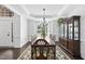 Elegant dining room with tray ceiling, large window, and hardwood floors at 55 Kristopher Woods Dr, Youngsville, NC 27596