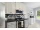 Bright kitchen featuring stainless steel appliances and ample cabinet space at 55 Kristopher Woods Dr, Youngsville, NC 27596