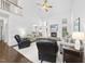 Bright living room with a fireplace, high ceilings, and hardwood floors at 55 Kristopher Woods Dr, Youngsville, NC 27596