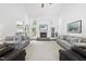 Spacious living room with fireplace, large windows, and neutral decor at 55 Kristopher Woods Dr, Youngsville, NC 27596