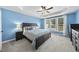 A spacious main bedroom provides neutral carpet, a tray ceiling, and large windows at 55 Kristopher Woods Dr, Youngsville, NC 27596