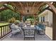 A sheltered outdoor lounge has patio furniture and a wooden pergola with a ceiling fan at 55 Kristopher Woods Dr, Youngsville, NC 27596