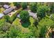 Aerial view of home with mature trees, red outbuilding, expansive lawn and serene, private setting at 6022 Little Creek Church Rd, Clayton, NC 27520