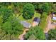 Aerial view of home with mature trees, outbuildings, and a long driveway, showcasing a serene setting at 6022 Little Creek Church Rd, Clayton, NC 27520