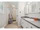 Bathroom features a shower with a curtain, vanity, and a storage cabinet at 6022 Little Creek Church Rd, Clayton, NC 27520