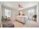 Neutral bedroom with two windows, a ceiling fan, and hardwood trim at 6022 Little Creek Church Rd, Clayton, NC 27520