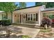 Inviting covered front porch with classic columns, complemented by comfortable seating and decorative touches at 6022 Little Creek Church Rd, Clayton, NC 27520