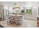 Bright kitchen featuring white cabinets, modern appliances, and a stylish center island with seating at 6022 Little Creek Church Rd, Clayton, NC 27520