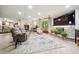 Cozy living room with a stone fireplace, comfortable seating, and an open layout at 6022 Little Creek Church Rd, Clayton, NC 27520