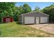 Features a practical two-car garage and an adjacent red shed, perfect for storage and hobbies at 6022 Little Creek Church Rd, Clayton, NC 27520