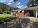 Well-maintained home with a covered carport, complemented by a lush lawn and mature trees at 607 S Smithfield Rd, Knightdale, NC 27545