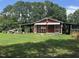 View of a red outbuilding with covered sheds, adding functionality and character to the property at 607 S Smithfield Rd, Knightdale, NC 27545