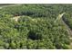 Aerial shot of land showcasing dense tree coverage, water features and road access for new development at 6736 Brixley Crest Ct, Raleigh, NC 27614
