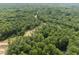 Land for development featuring a winding road, dense trees and a pond, perfect for a private community at 6736 Brixley Crest Ct, Raleigh, NC 27614