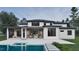 Expansive backyard featuring a modern pool, covered patio, and seamless indoor-outdoor living at 6736 Brixley Crest Ct, Raleigh, NC 27614