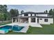 Expansive backyard with a pool, covered patio, and modern home architecture at 6736 Brixley Crest Ct, Raleigh, NC 27614