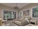 Spacious bedroom with a large bed, sliding glass doors, and an outdoor seating area at 6736 Brixley Crest Ct, Raleigh, NC 27614