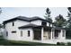 Modern two-story home featuring a covered patio with stone fireplace, set in a beautifully landscaped yard at 6736 Brixley Crest Ct, Raleigh, NC 27614