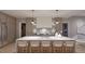 Modern kitchen featuring a large island with seating, stainless steel appliances, and custom cabinetry at 6736 Brixley Crest Ct, Raleigh, NC 27614