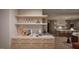 An open kitchen with light wood cabinets, marble countertops, and stainless steel appliances at 6736 Brixley Crest Ct, Raleigh, NC 27614