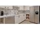 A modern kitchen with white cabinets, stainless steel appliances, and decorative tile backsplash at 6736 Brixley Crest Ct, Raleigh, NC 27614