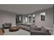 Spacious living room with neutral palette, multiple windows and comfortable modern furniture at 6736 Brixley Crest Ct, Raleigh, NC 27614