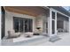 Comfortable covered patio with cozy seating around a stone fireplace with pool view at 6736 Brixley Crest Ct, Raleigh, NC 27614