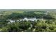 Picturesque aerial view showcasing a community near a calm lake surrounded by lush green forest at 7309 Forest Glade Ct, Raleigh, NC 27615