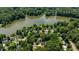 Aerial view of a charming community nestled around a lake and surrounded by lush green trees at 7309 Forest Glade Ct, Raleigh, NC 27615