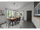 The dining room featuring a wooden table with fabric chairs, modern lighting, and tile floors at 7309 Forest Glade Ct, Raleigh, NC 27615