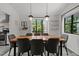 Bright dining room with a large wooden table, comfortable seating, and large windows with scenic views at 7309 Forest Glade Ct, Raleigh, NC 27615