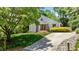 Charming home showcasing a well-manicured lawn and concrete driveway leading up to the front entrance and a tree at 7309 Forest Glade Ct, Raleigh, NC 27615