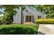The front of a home has a gray, modern design, featuring a chimney and lush green grass at 7309 Forest Glade Ct, Raleigh, NC 27615
