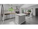 Modern kitchen with white cabinets, stainless steel appliances, and a center island. Also features an eat-in dining area at 7309 Forest Glade Ct, Raleigh, NC 27615