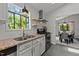 Well-lit kitchen with updated appliances, granite countertops, floating shelves, and an eat-in dining area at 7309 Forest Glade Ct, Raleigh, NC 27615